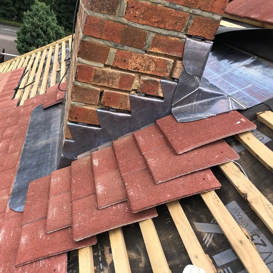 Chimney with new lead soakers and red tiles going on