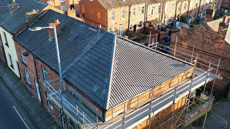 Drone view of a new hipped roof on an end terrace with scaffold round it