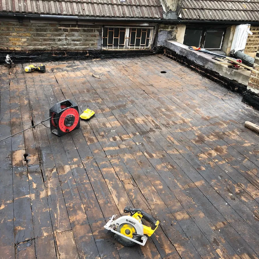 Flat roof stripped back to the deck before the new covering