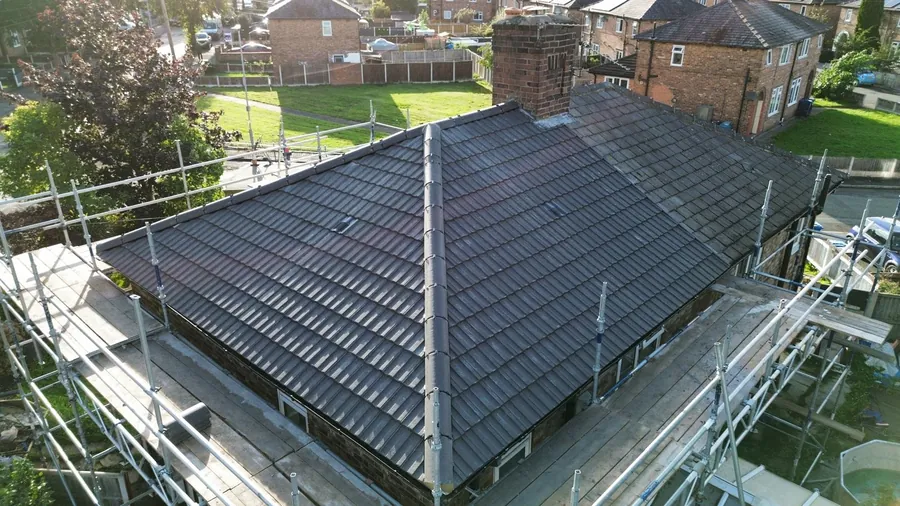 New grey interlocking tile hip roof finished with the scaffold still up