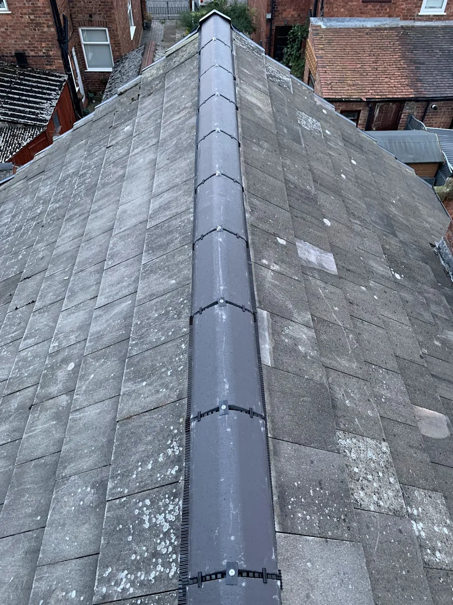 Grey roof with a new dry ridge fitted along the top