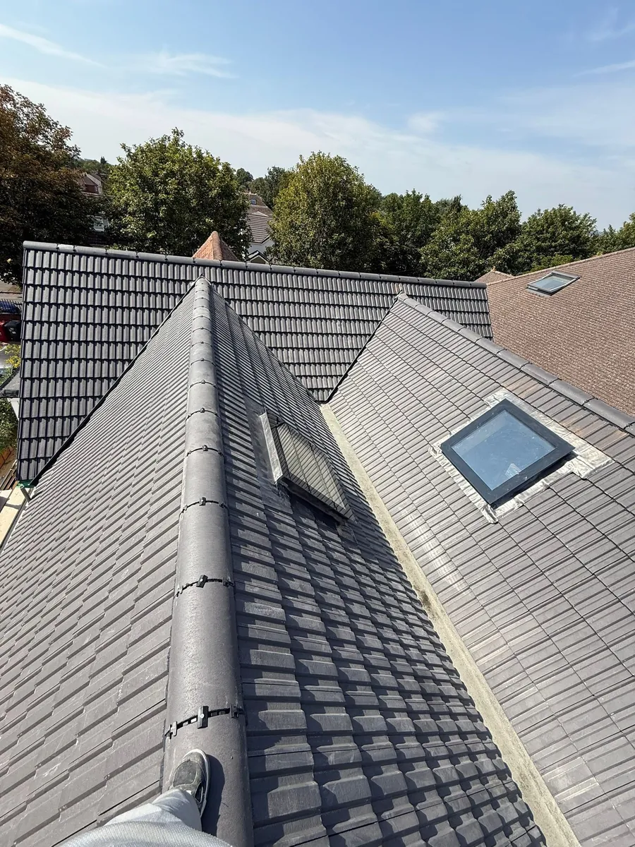 Grey tile roof with new roof windows and a dry ridge
