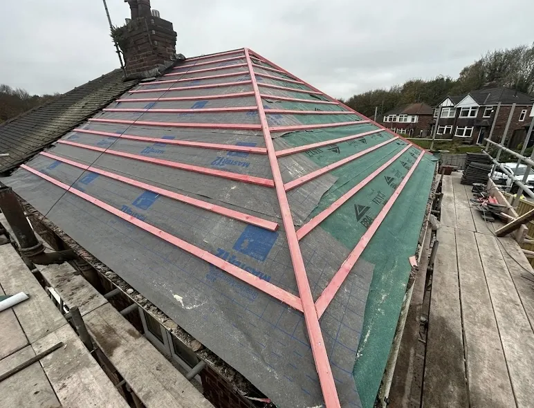 Hip roof with new membrane and red-marked battens