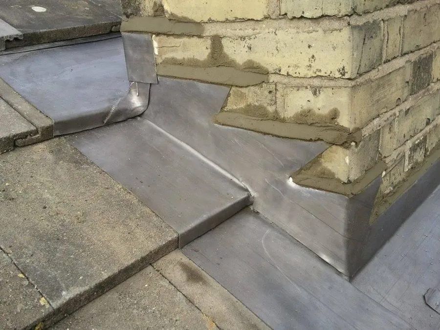 Lead work round a chimney at a flat roof