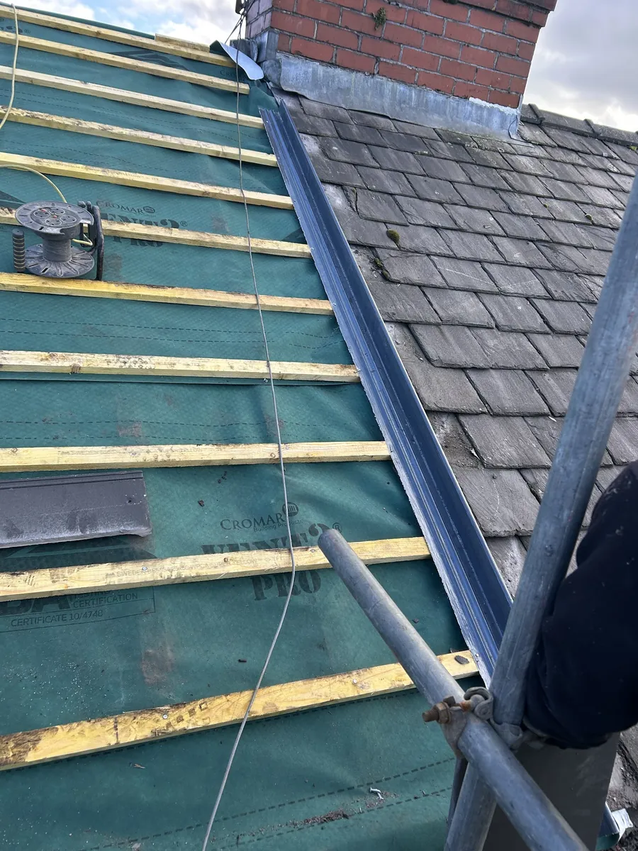 New membrane and battens up to a chimney with lead flashing