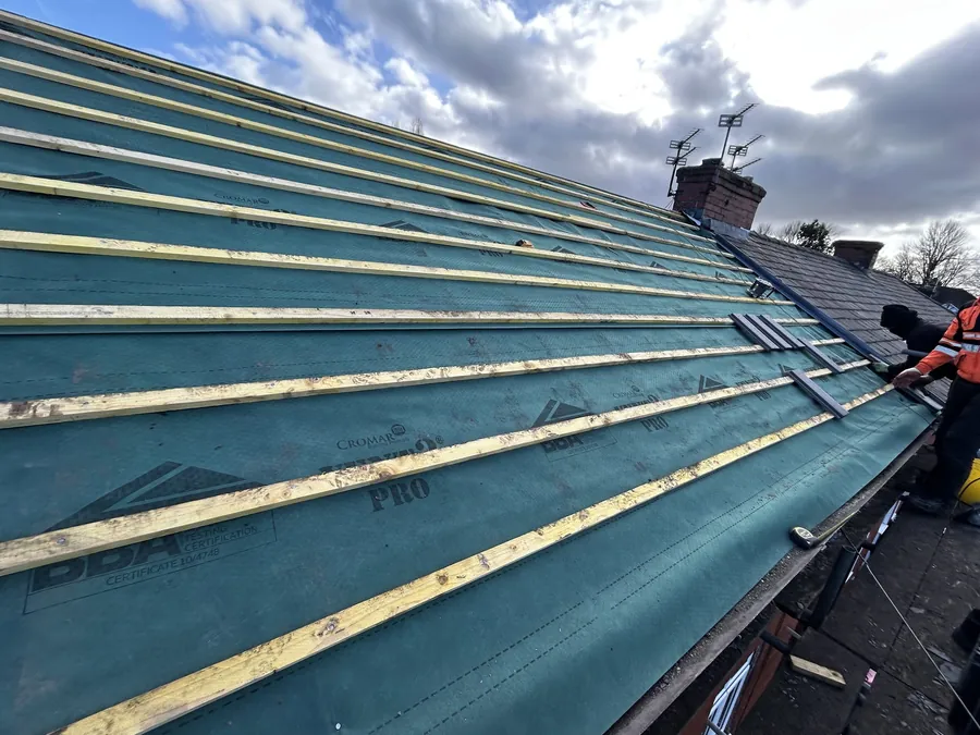 Green breathable membrane and new battens across a roof slope