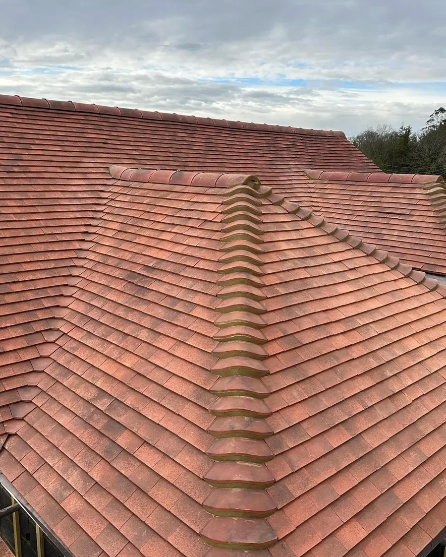Red plain tile roof with a finished hip