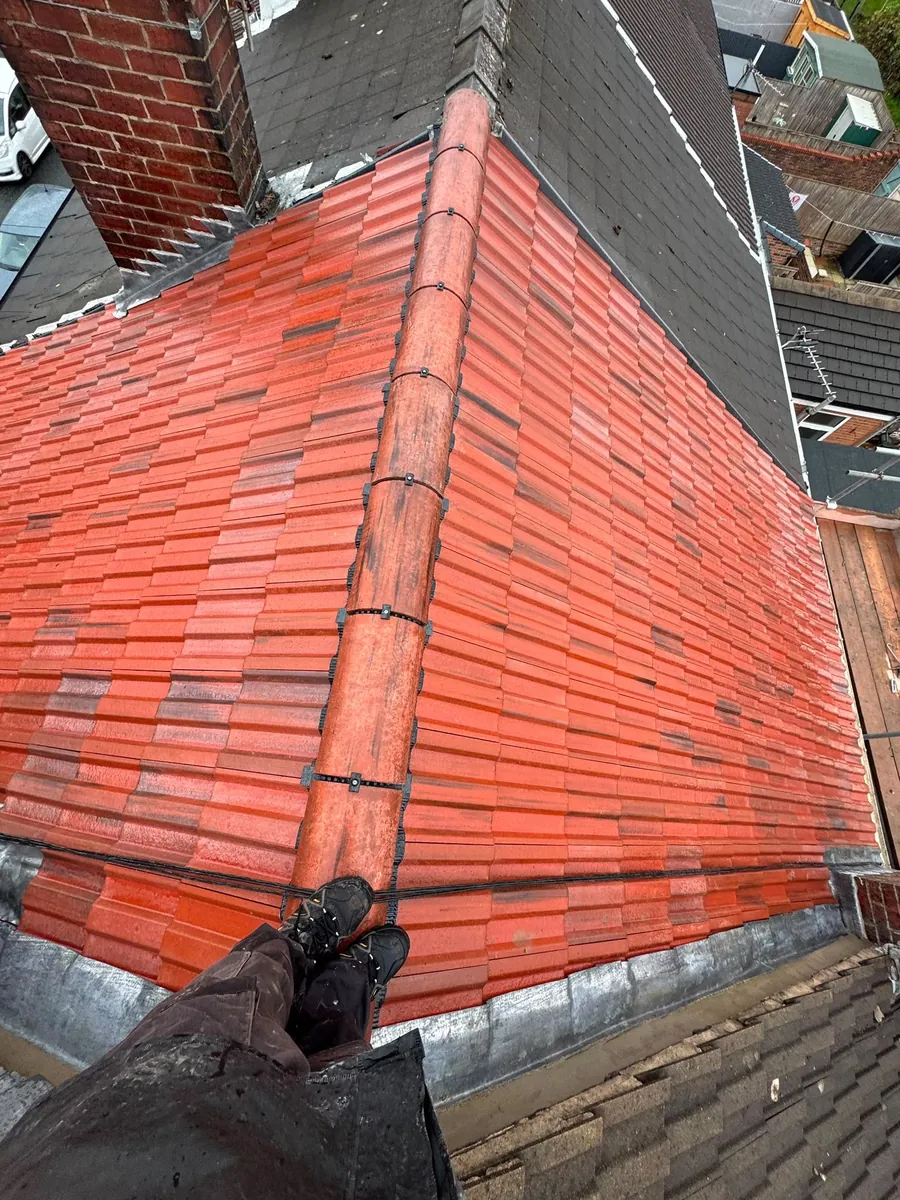 Close view of a red tile hip from the roof