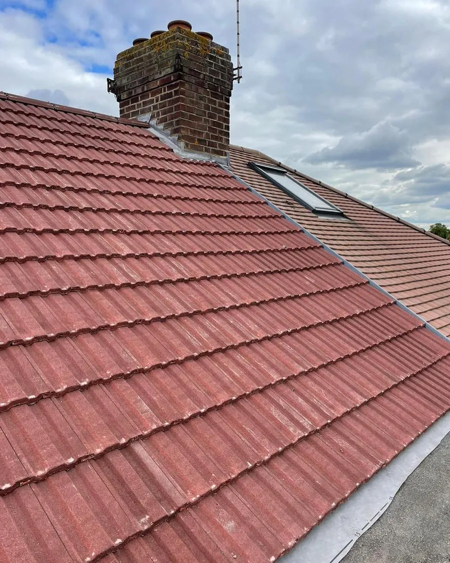 Red tile roof with a chimney and roof window