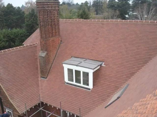 Red tile roof with a white dormer window
