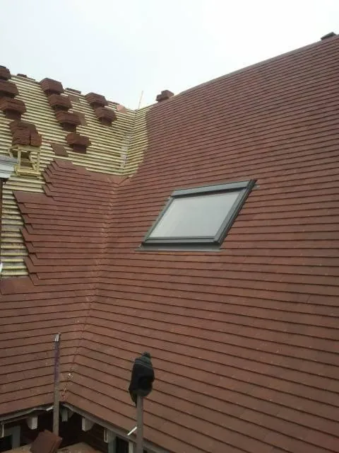 Red tile roof with a new roof window