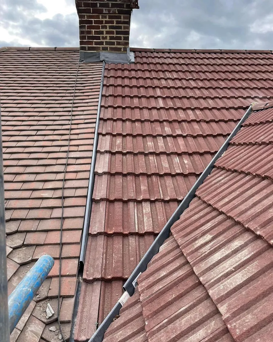 Red tiles either side of a new lead valley