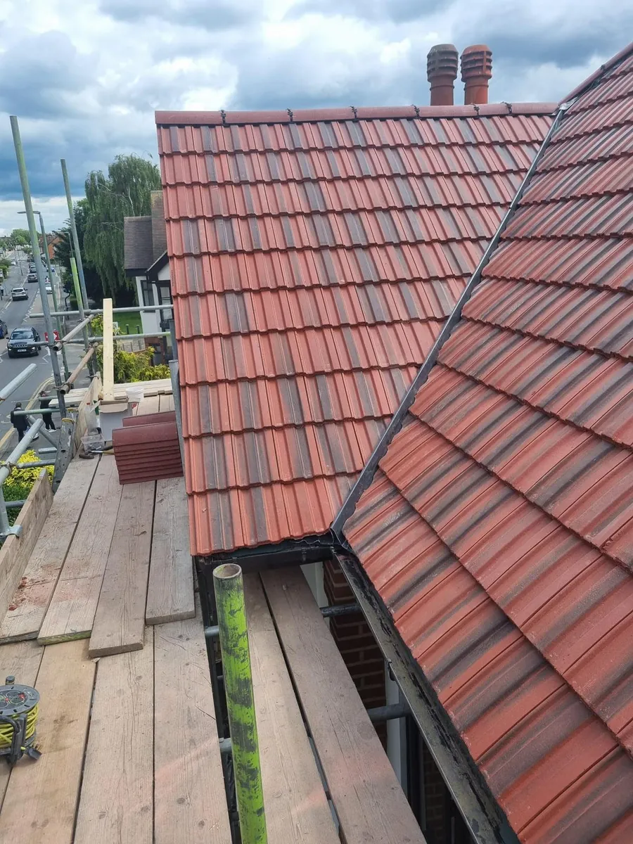 Red interlocking tiles at a valley, seen from the scaffold