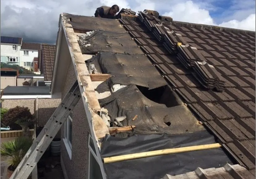 Roof part stripped with the old felt and tiles coming off