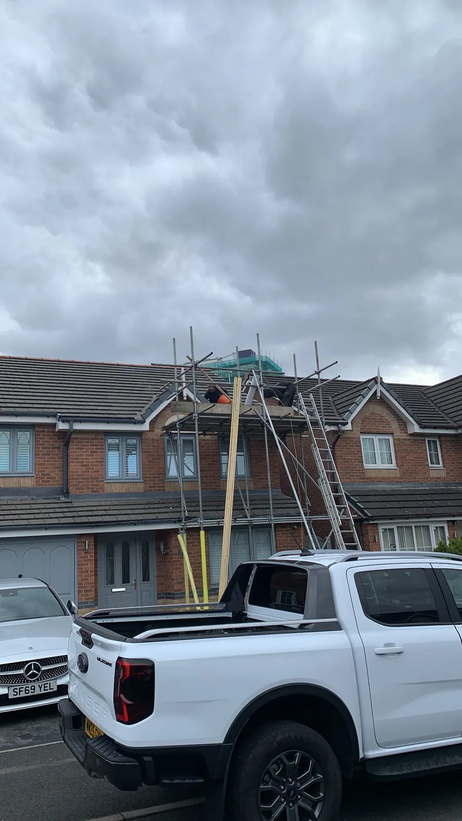 Scaffold up on a house with the work pickup outside