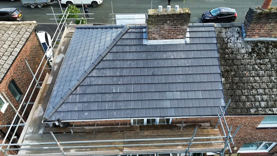 Slate-effect tiles laid between two chimney stacks on a terrace