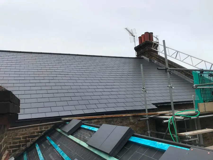 Slate roof with scaffold up for dormer work