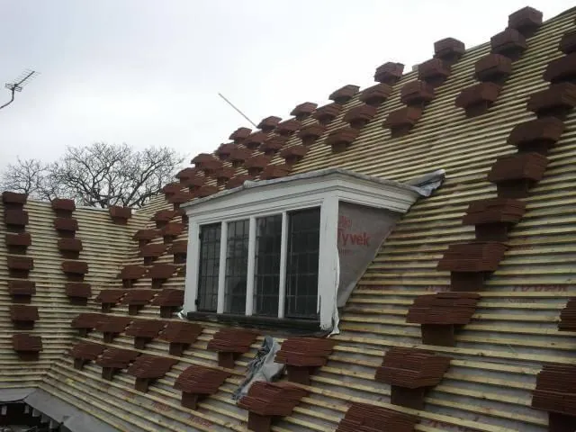 Tiles loaded around a dormer during a re-roof